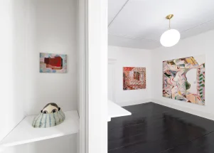 gallery installation of oil paintings and one sculpture