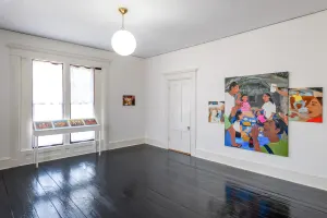 gallery installation four marker drawings on a shelf, a small oil painting in the corner, and a triptych oil painting on the near wall