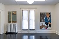 gallery installation of two oil paintings between two rooms