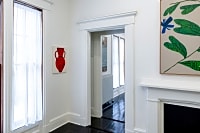 gallery installation of oil paintings on a wall