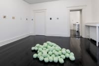gallery installation of a large oil painting and three marker drawings on a shelf above a radiator