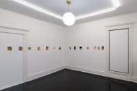 gallery installation four marker drawings on a shelf, a small oil painting in the corner, and a triptych oil painting on the near wall