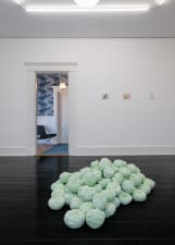 long shot of a gallery installation featuring 6 artworks with a large bay window in between
