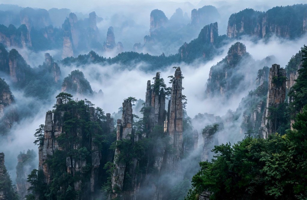 Sandstone pillars rising through morning mist