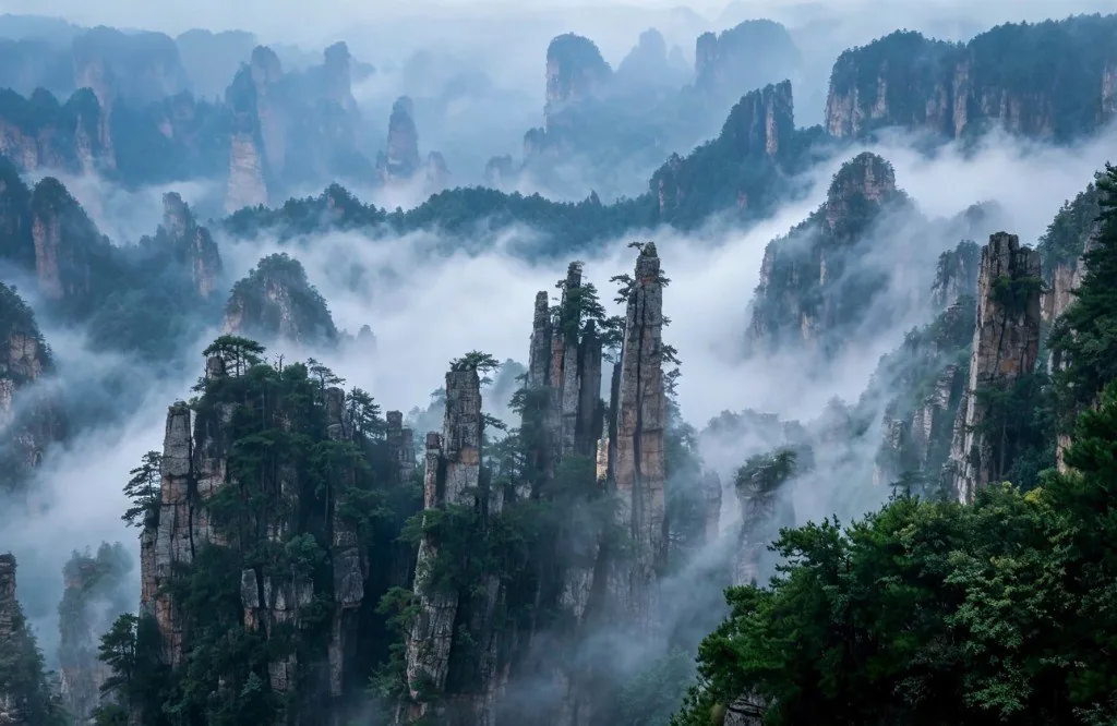 Sandstone pillars rising through morning mist