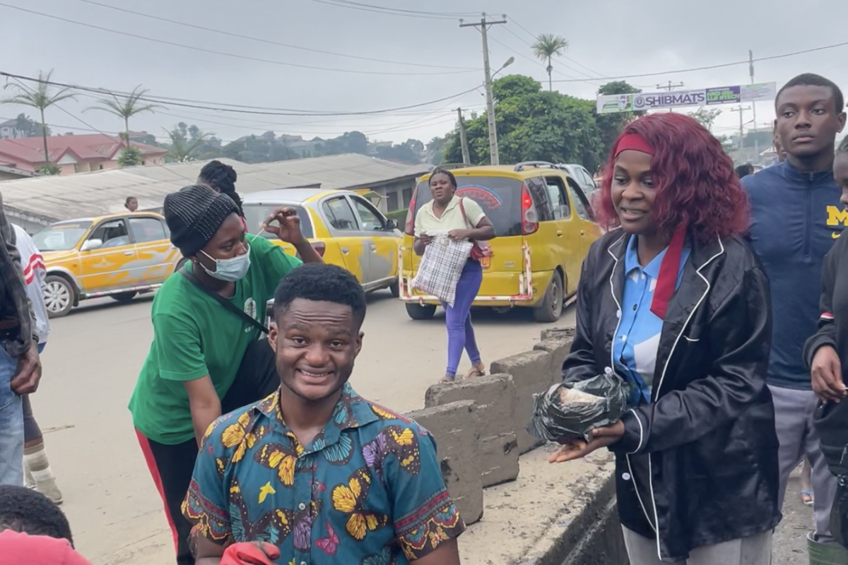 Volunteers gather along a roadside during the community clean-up