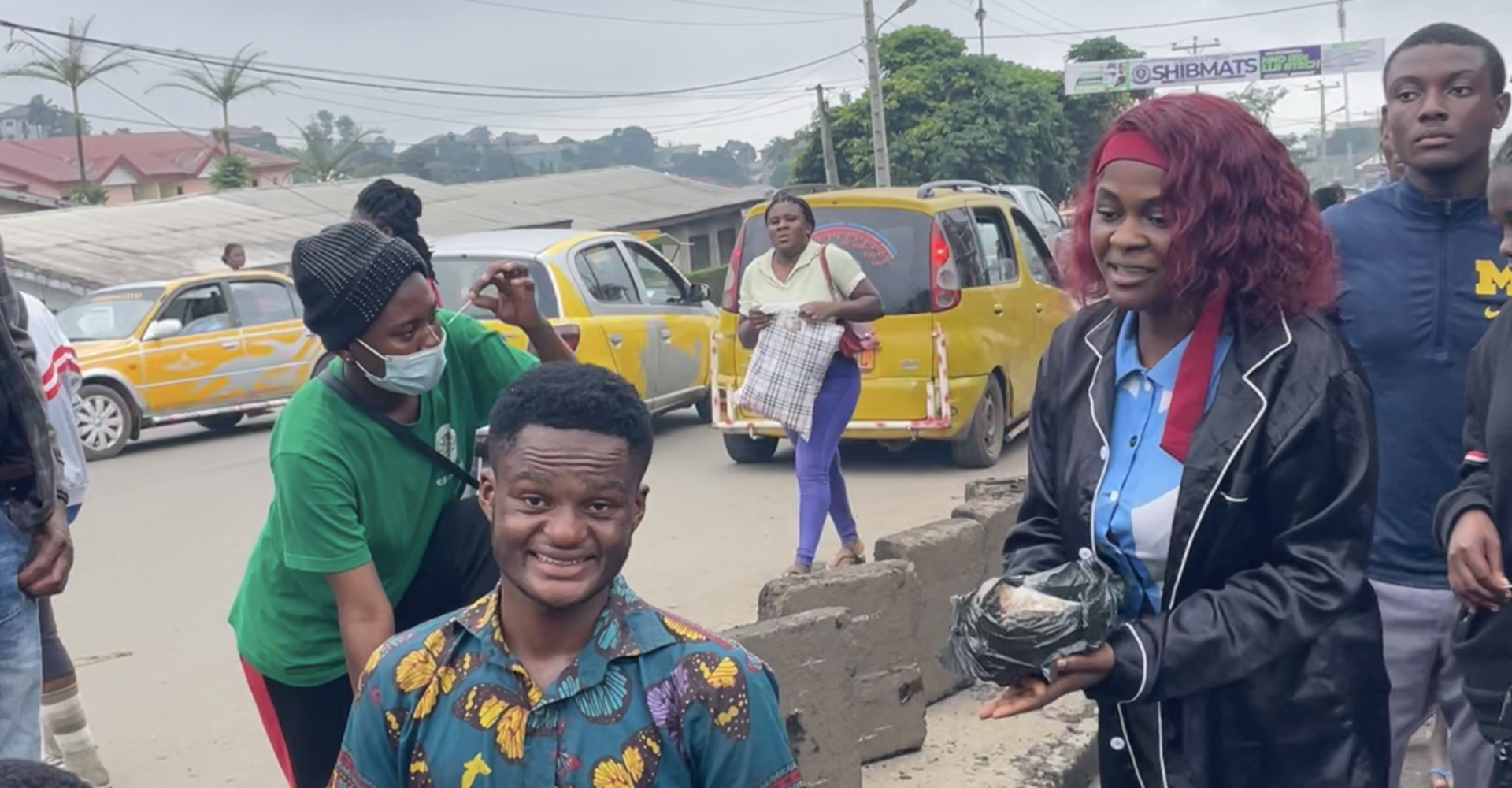 Volunteers gather along a roadside during the community clean-up
