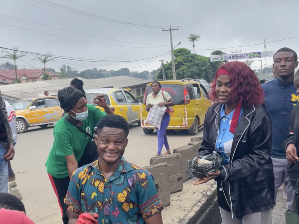 Volunteers gather along a roadside during the community clean-up