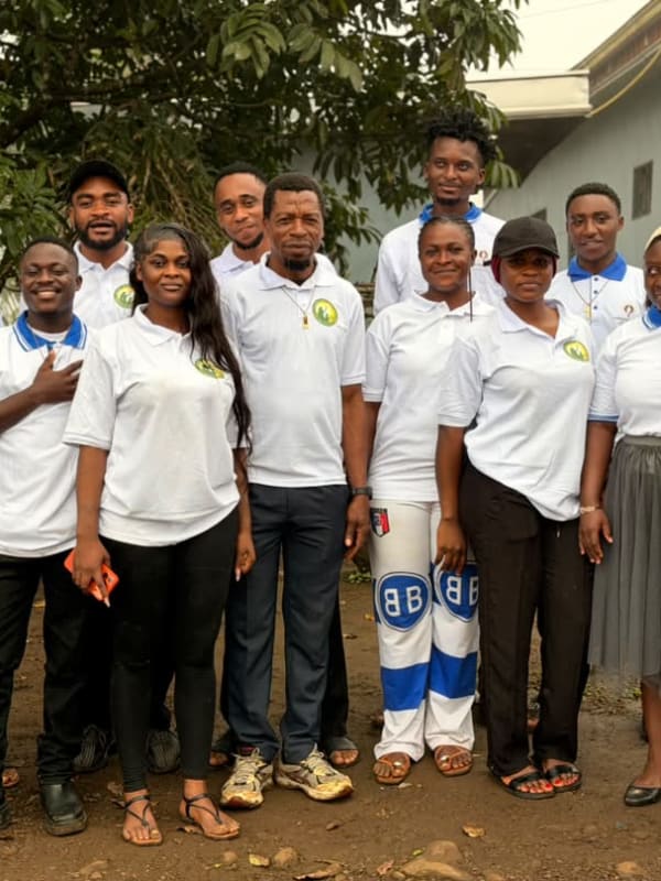 Members of the Foundation team and volunteers, most in its logo polo shirts, pose for a group photo