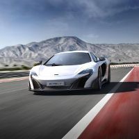 McLaren P1 car on the road with mountains in the background