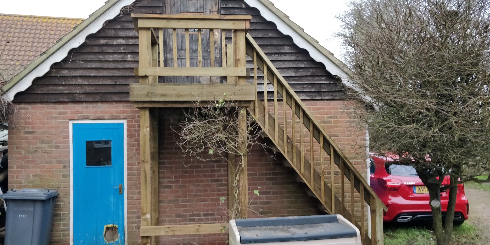 External staircase going into office space above double garage
