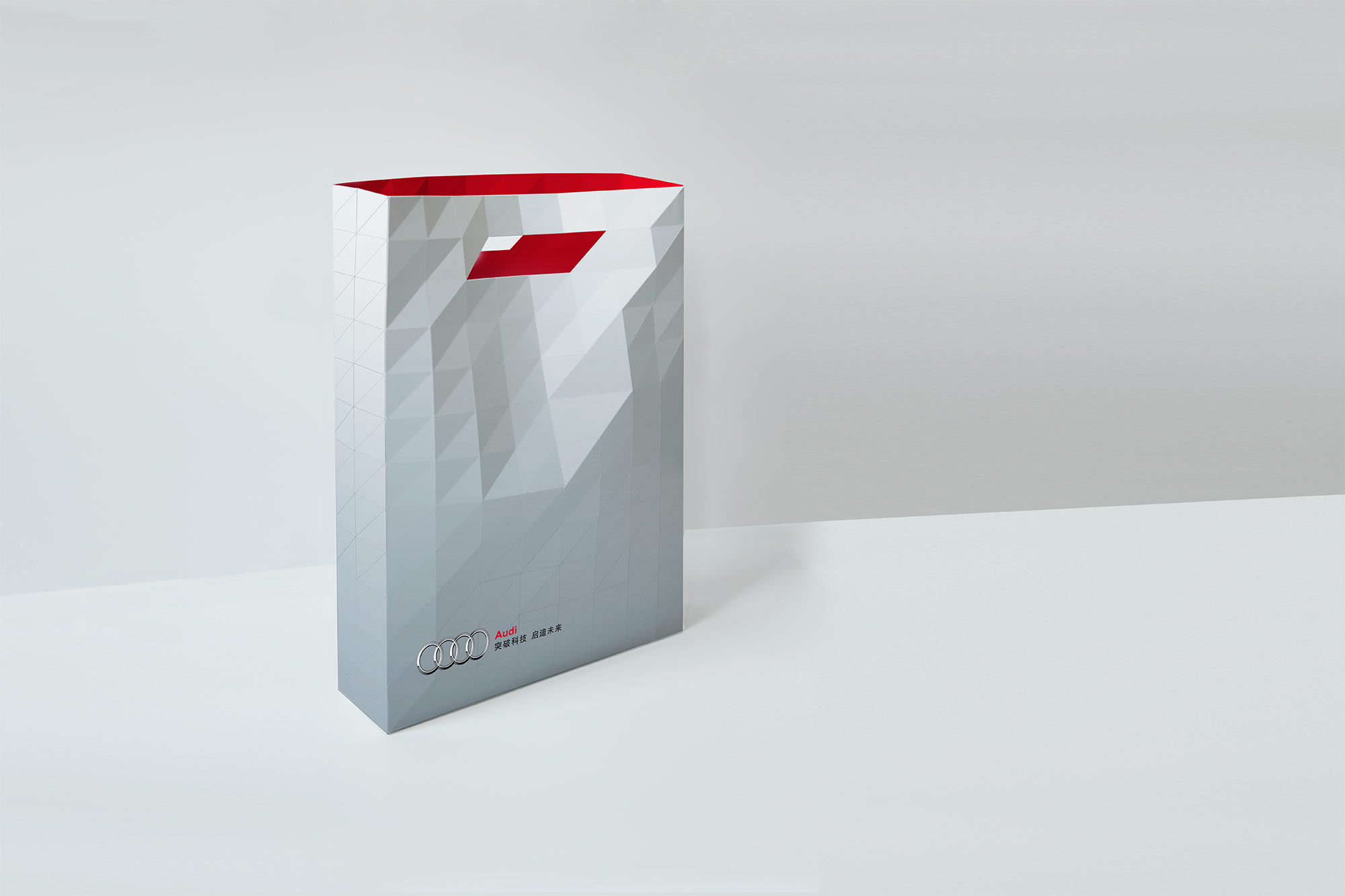 White paper bag with Audi logo with red inside