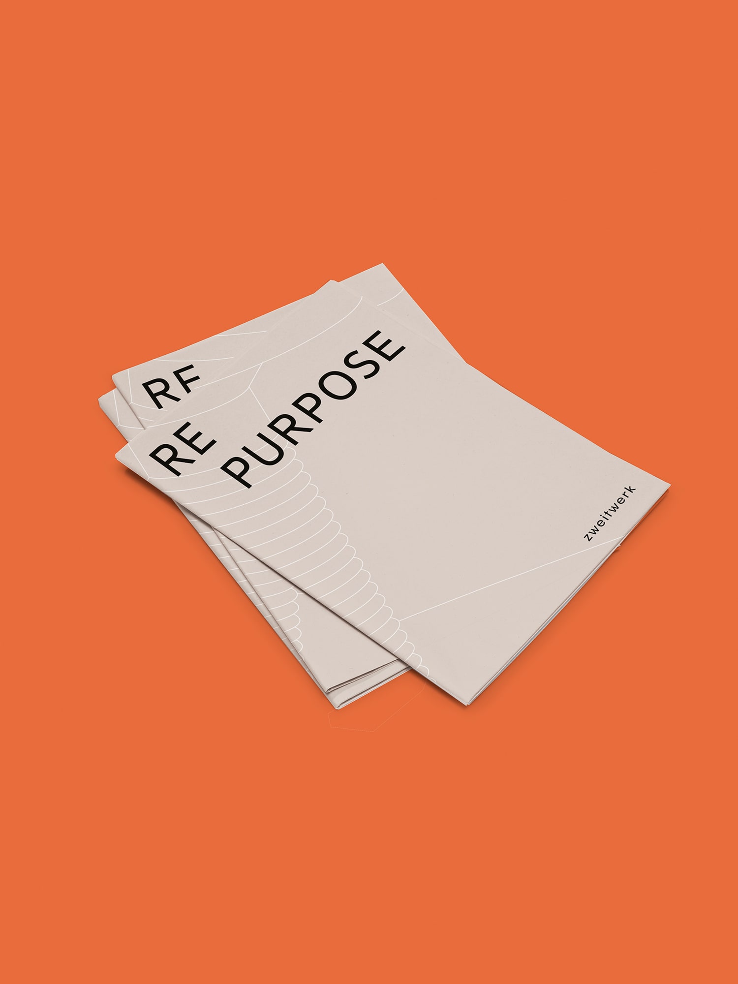 Mock-up of light gray booklet on orange background for campaign. Cover title: Repurpose.