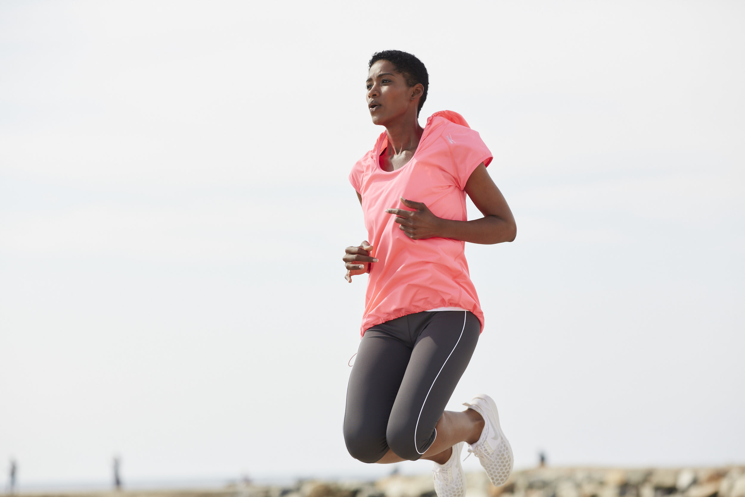 Jumping woman in sports clothes