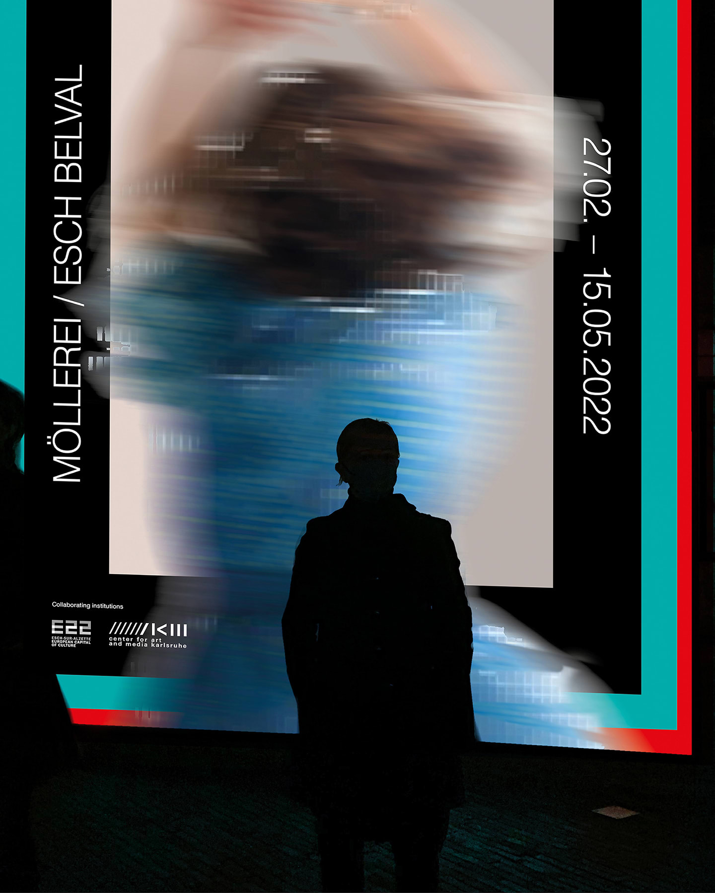 Silhouette of a person in front of a ZKM poster