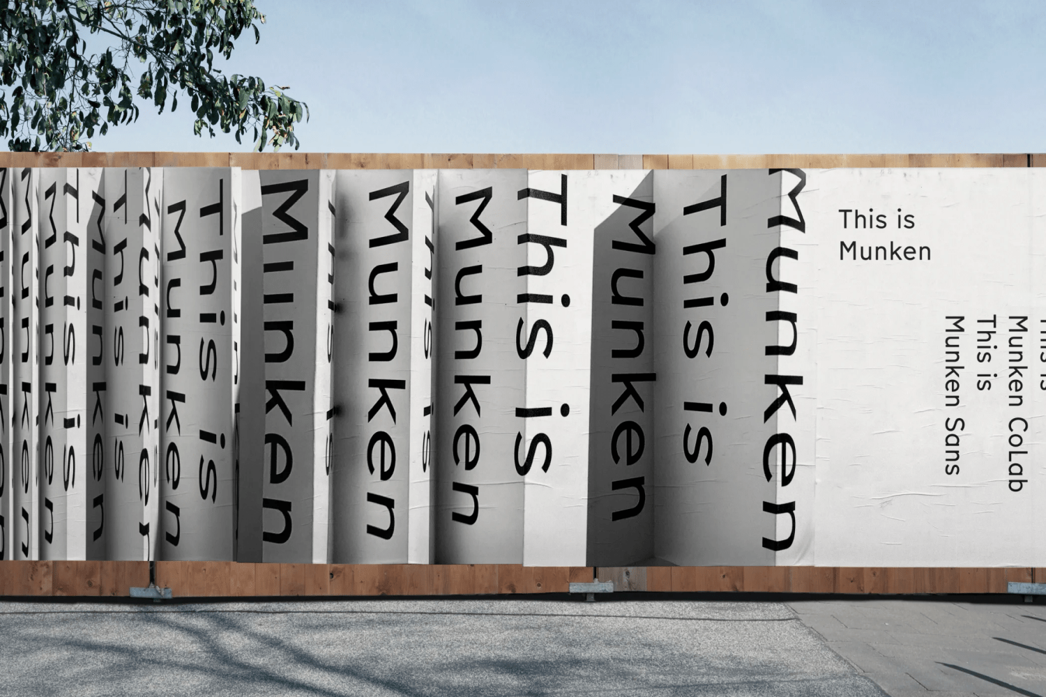 Posters on a wooden wall outside. Posters show text on it. Text says 