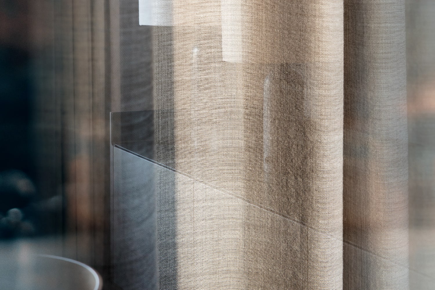 Double exposure of a brown curtain and a black kitchen counter. Photography for the campaign.