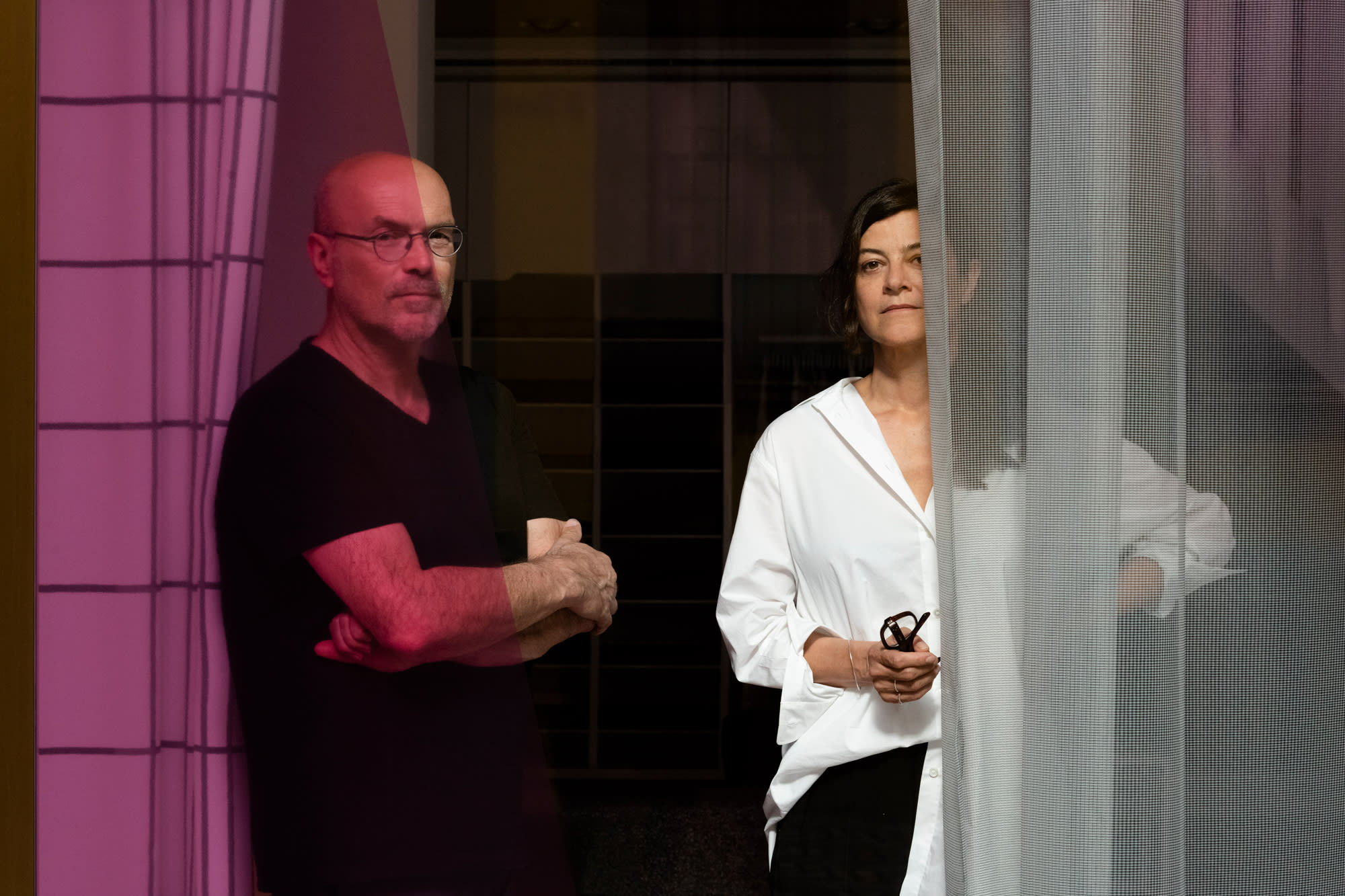 Isa Glink and Alain Biltereyst framed by curtains