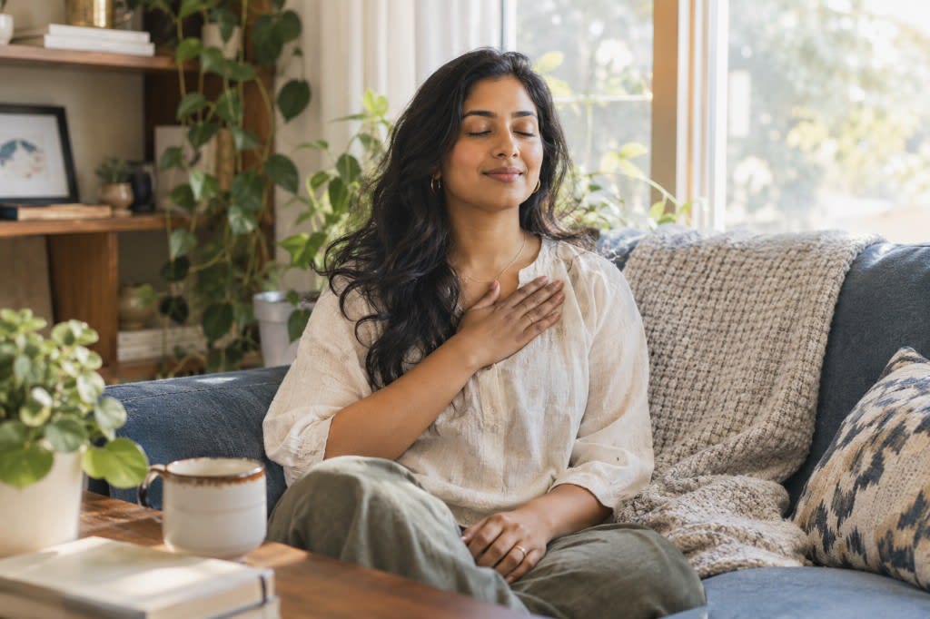 Woman practicing a gentle self-compassion exercise.
