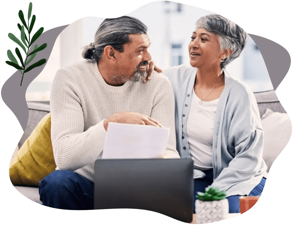 A happy couple on computer working with an online couples therapist and doing online marriage counseling virtually
