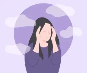 A person looking stressed and overwhelmed, representing the triggers and causes of derealization