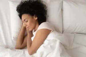 A person sleeping peacefully in their bed