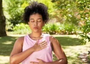A person practicing self-regulation techniques, such as deep breathing and body awareness