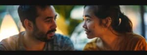 A man and a woman sit facing each other, deeply engaged in conversation, exemplifying couples communication and effective listening.
