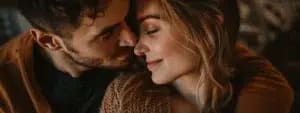 Close-up of a couple with their faces touching, eyes closed, and smiling softly in a warm, intimate embrace— an image that captures the essence of better communication.