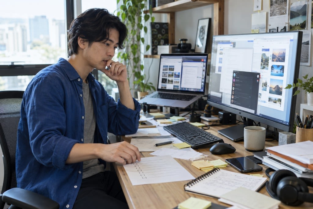 A desk with two screens of open tabs, scattered notes, and a half-finished checklist: working memory past its limit