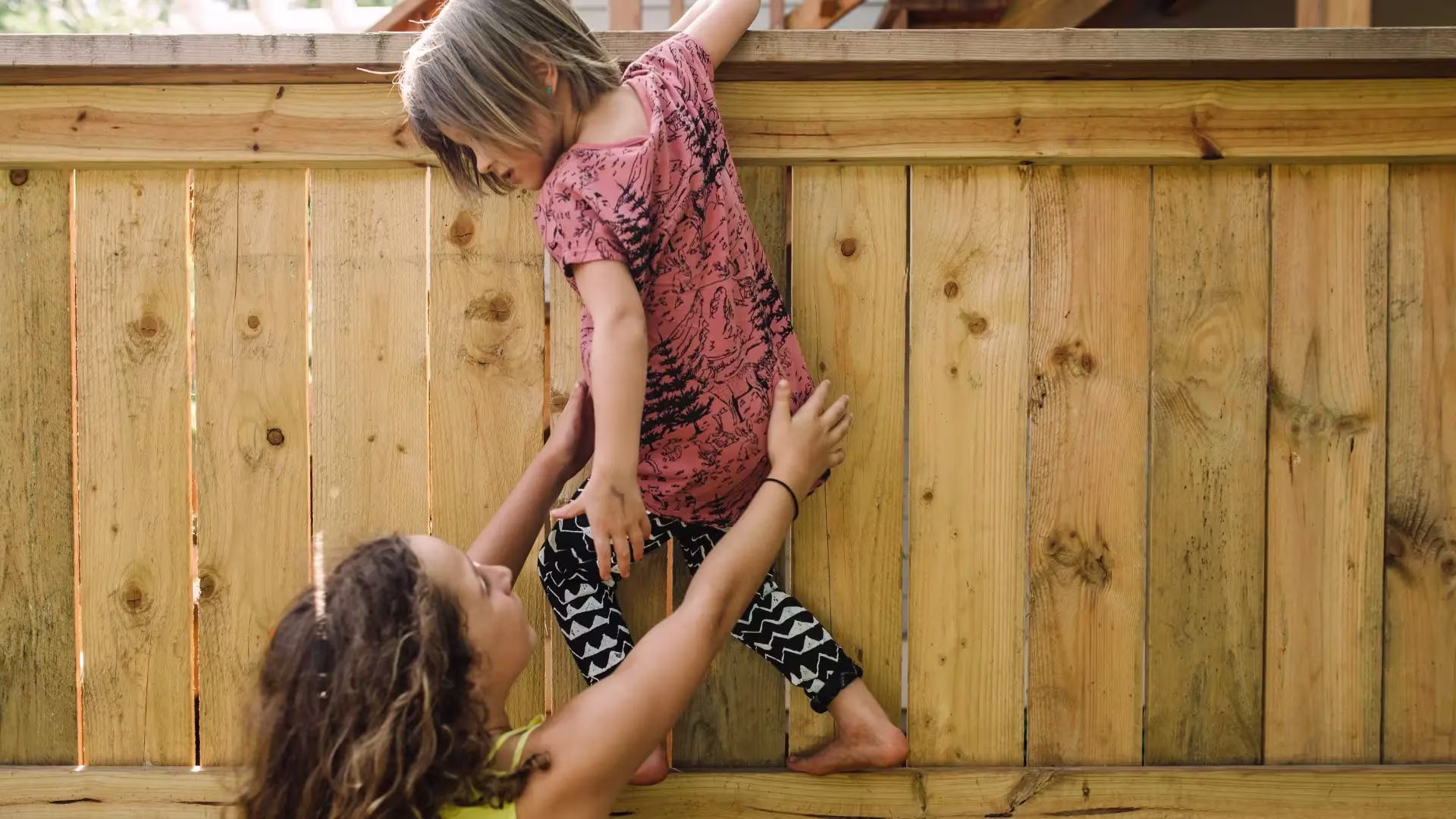 a mom helping a child get off the fence representing group therapy in san francisco for schema awareness and insecure at