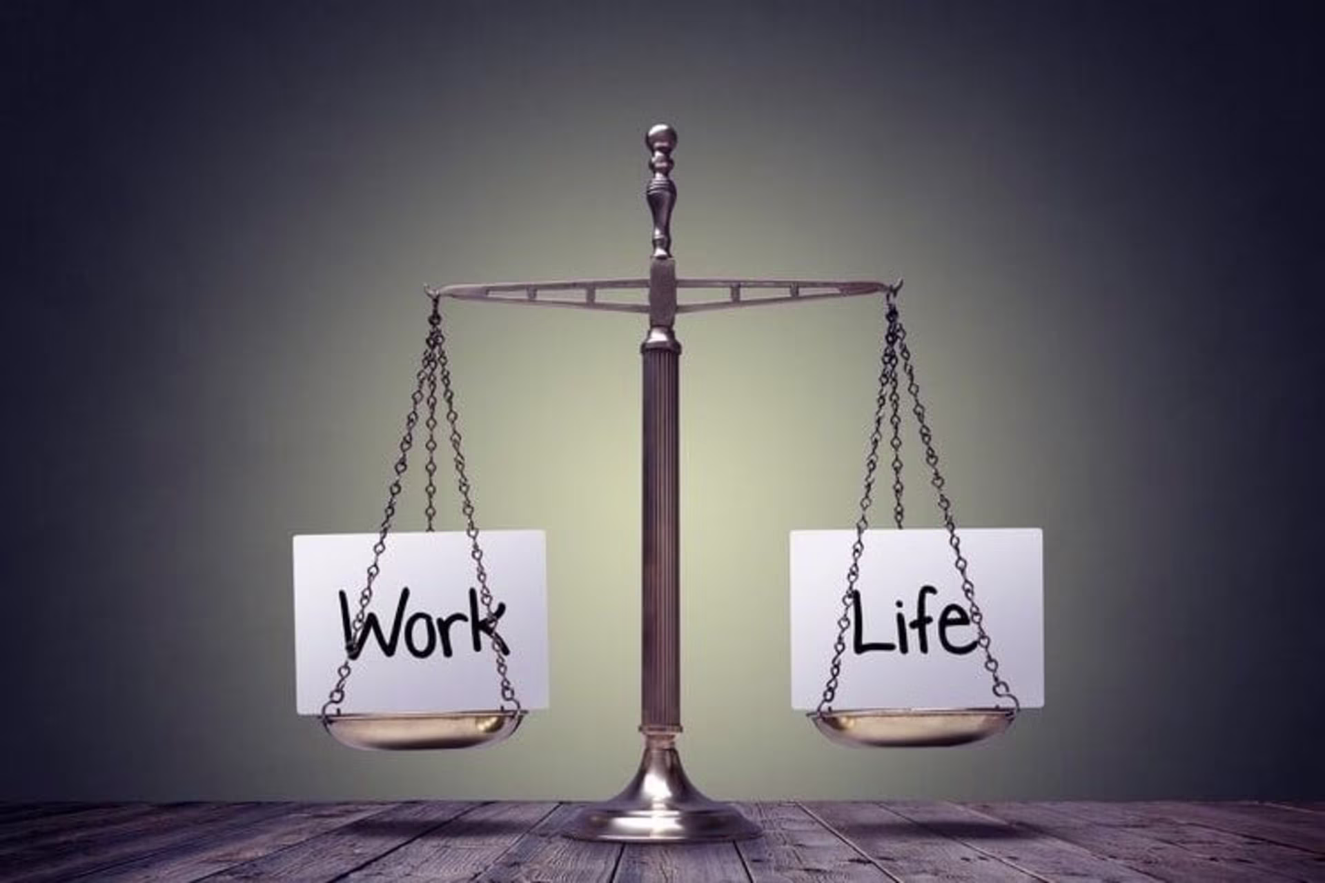 A balanced scale with "Work" on one side and "Life" on the other, symbolizing work-life balance; a c