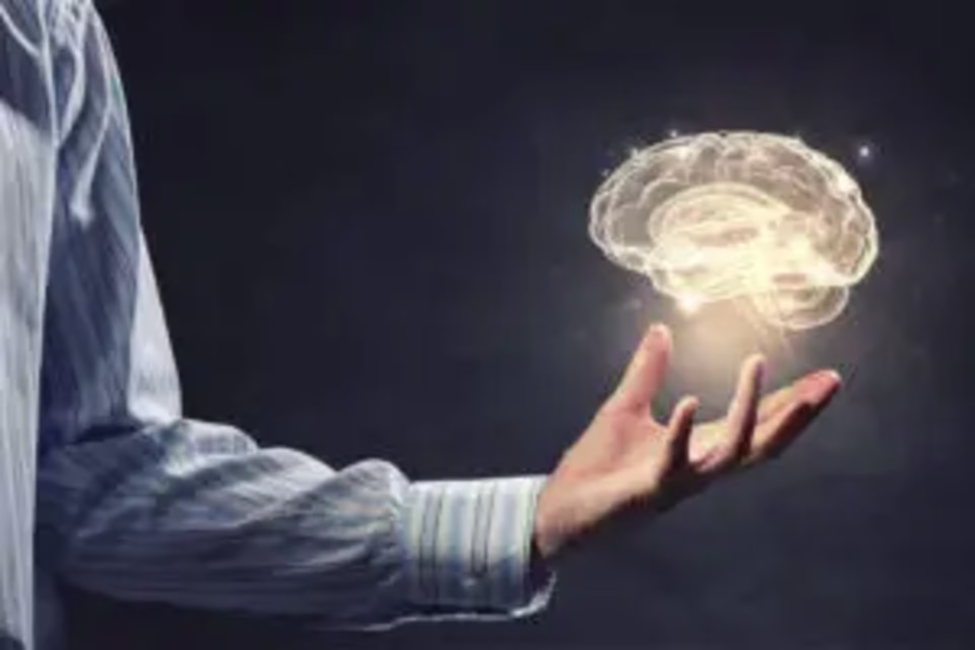 a man holding a brain to try to understand the neuronal wiring connected to procrastination 