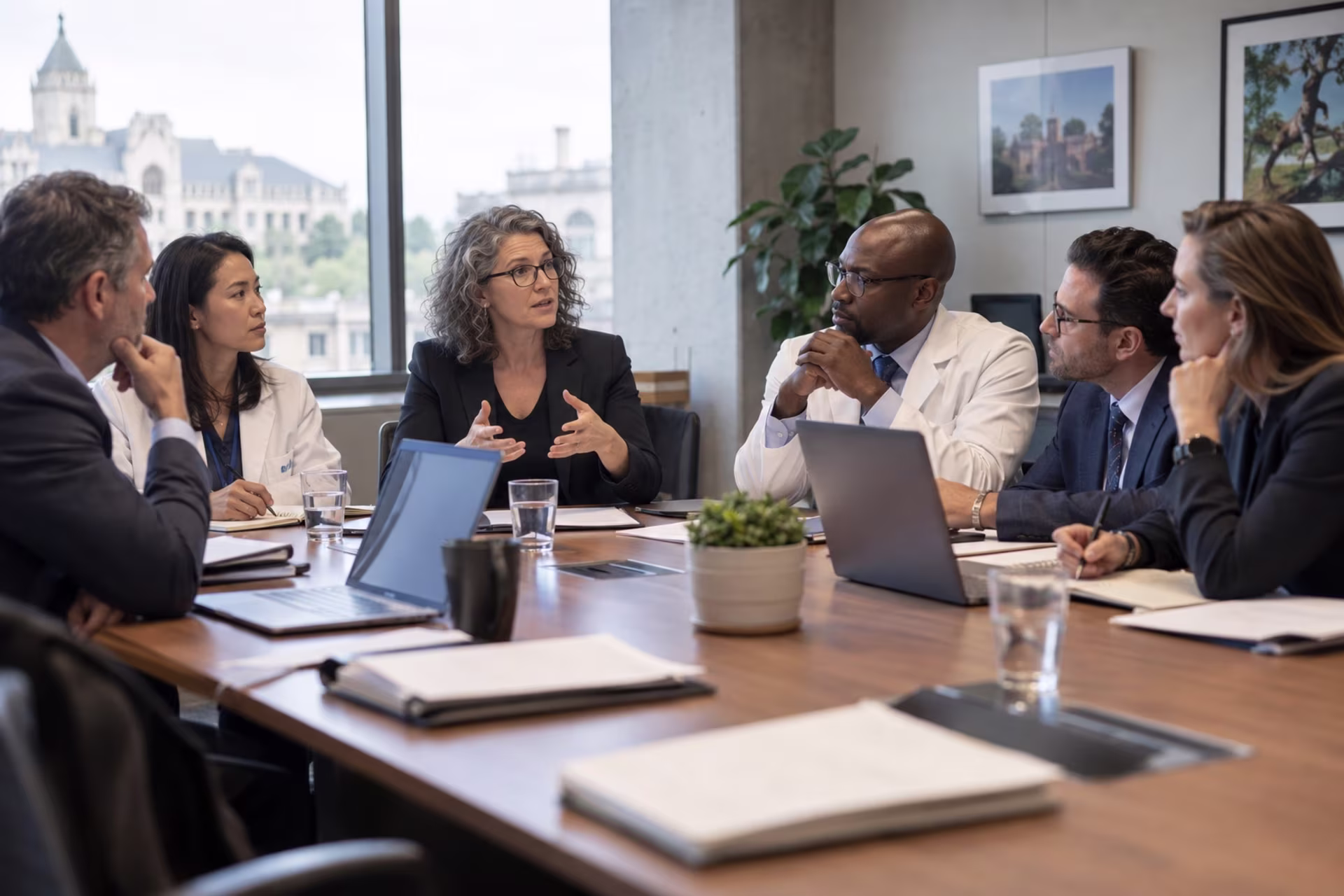 Medical professionals and policy experts sit around a conference table discussing healthcare regulation.