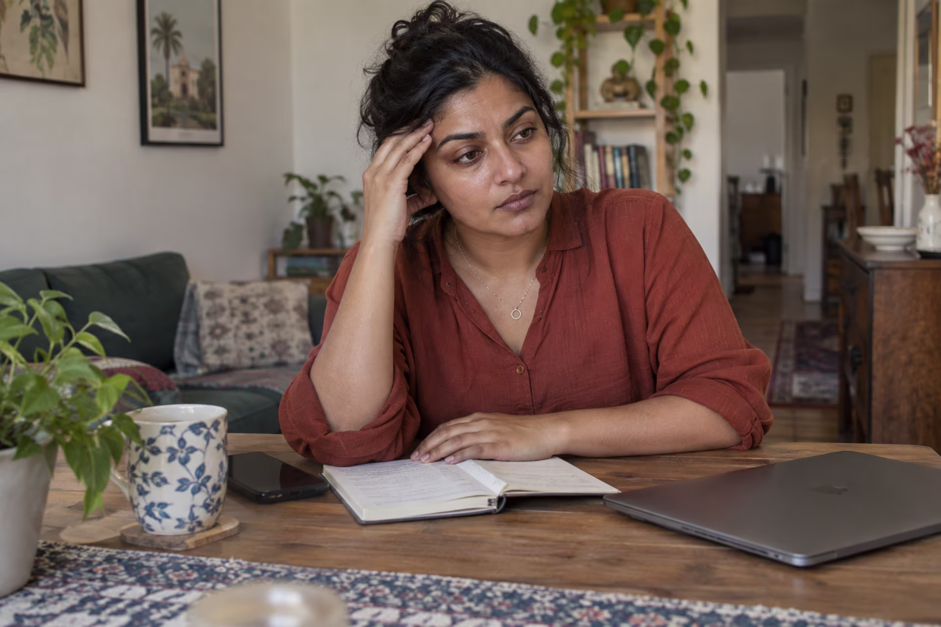 Woman taking a pause while feeling the strain of a difficult decision.