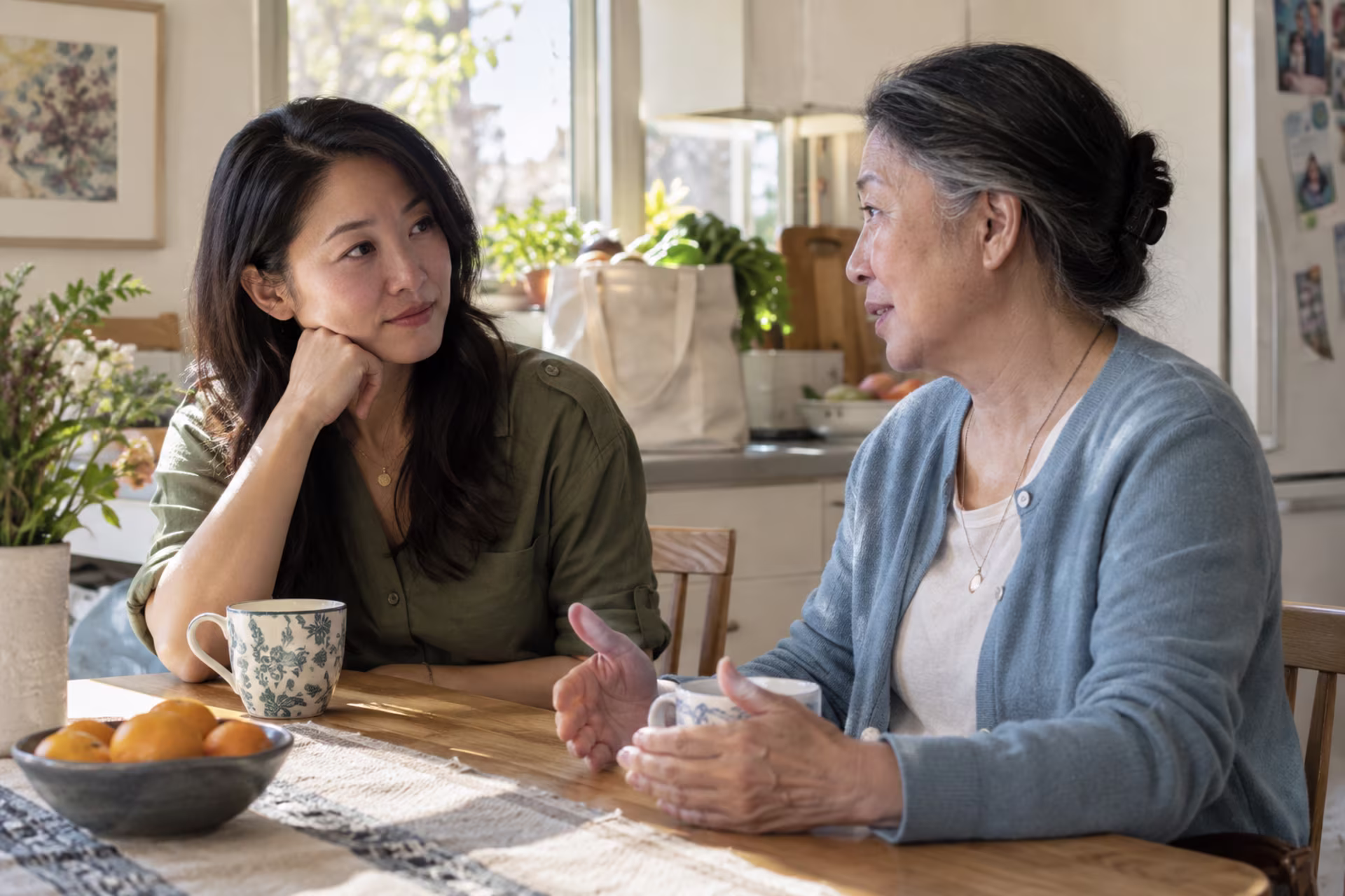 Adult daughter and mother discussing family responsibilities with care and concern.