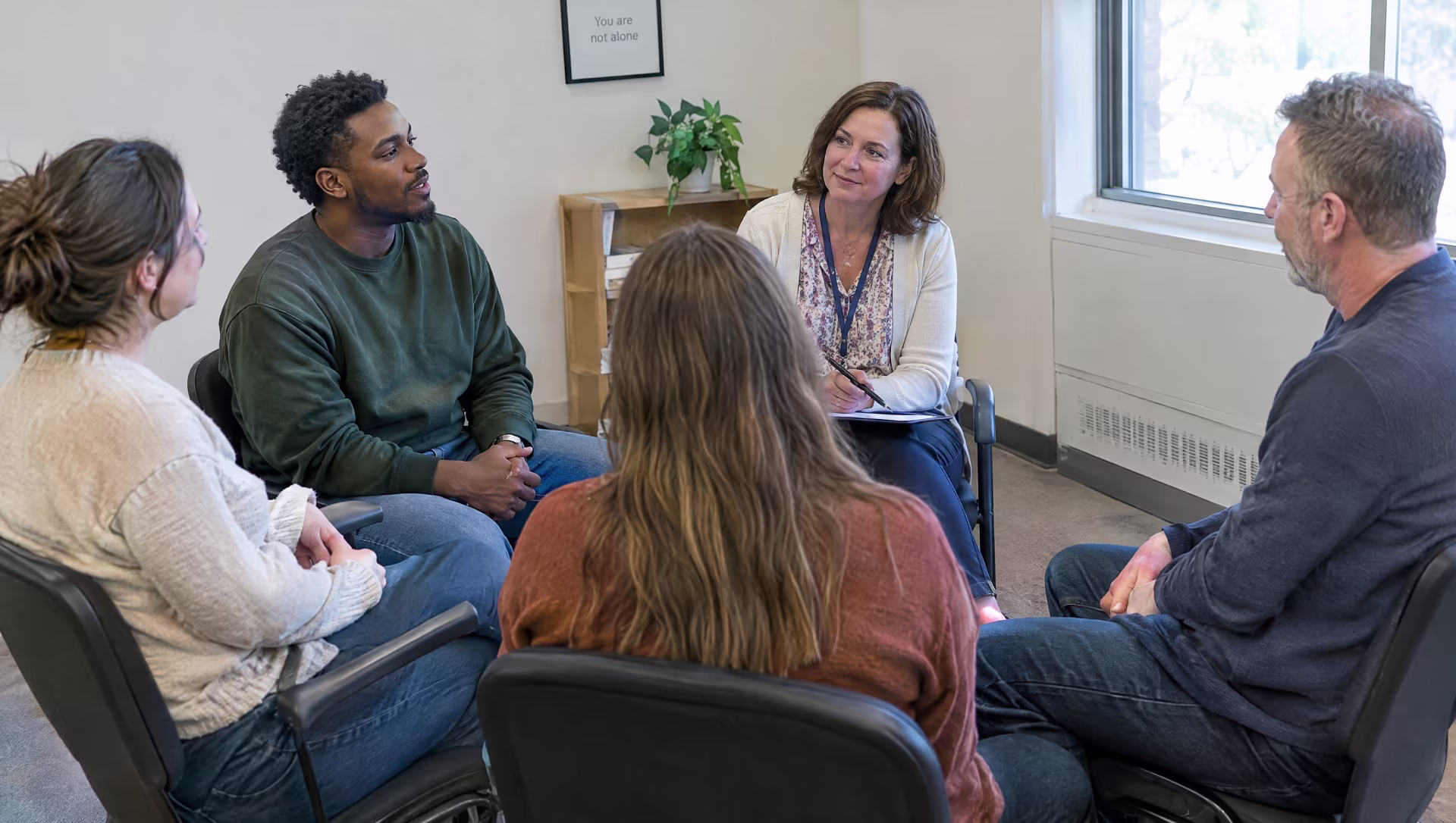 Adults in an in-person group therapy session