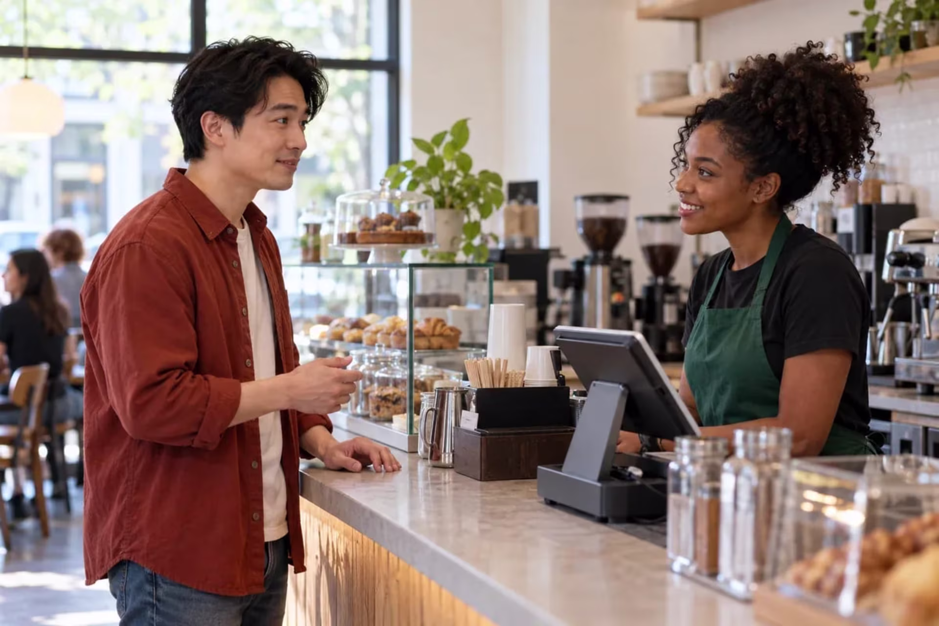 Man practicing a brief social interaction by ordering at a cafe counter.