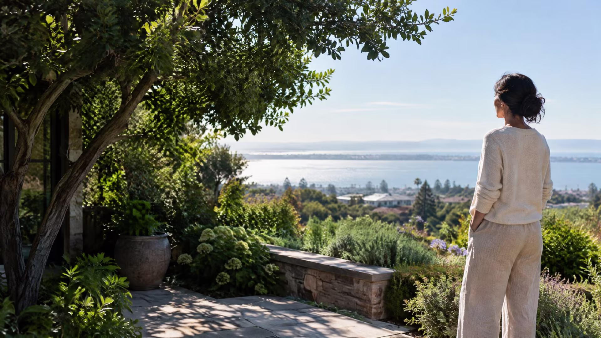 Adult standing on a garden terrace beside leafy trees in the South Bay, OCD therapy in San Jose near me