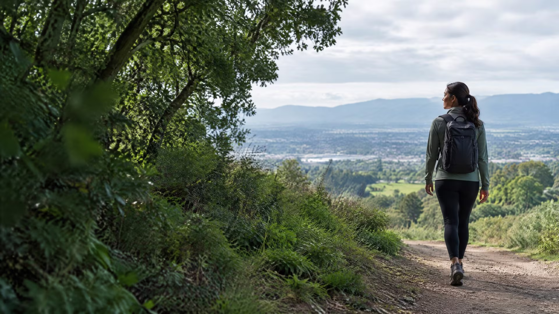 Adult walking along a leafy South Bay hillside trail, anxiety therapy in San Jose near me