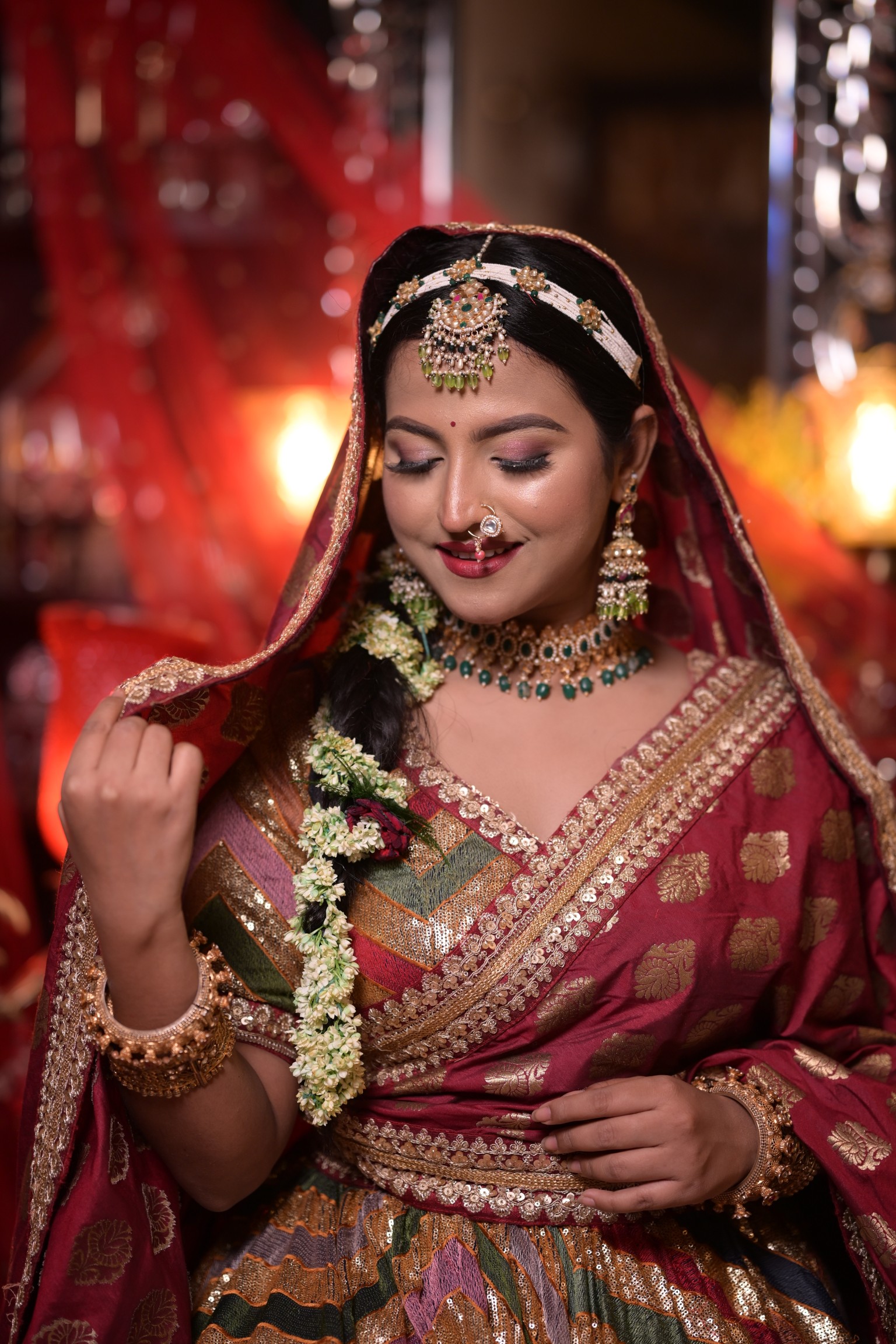Beautiful Indian bride with traditional bridal makeup and floral hairstyle.