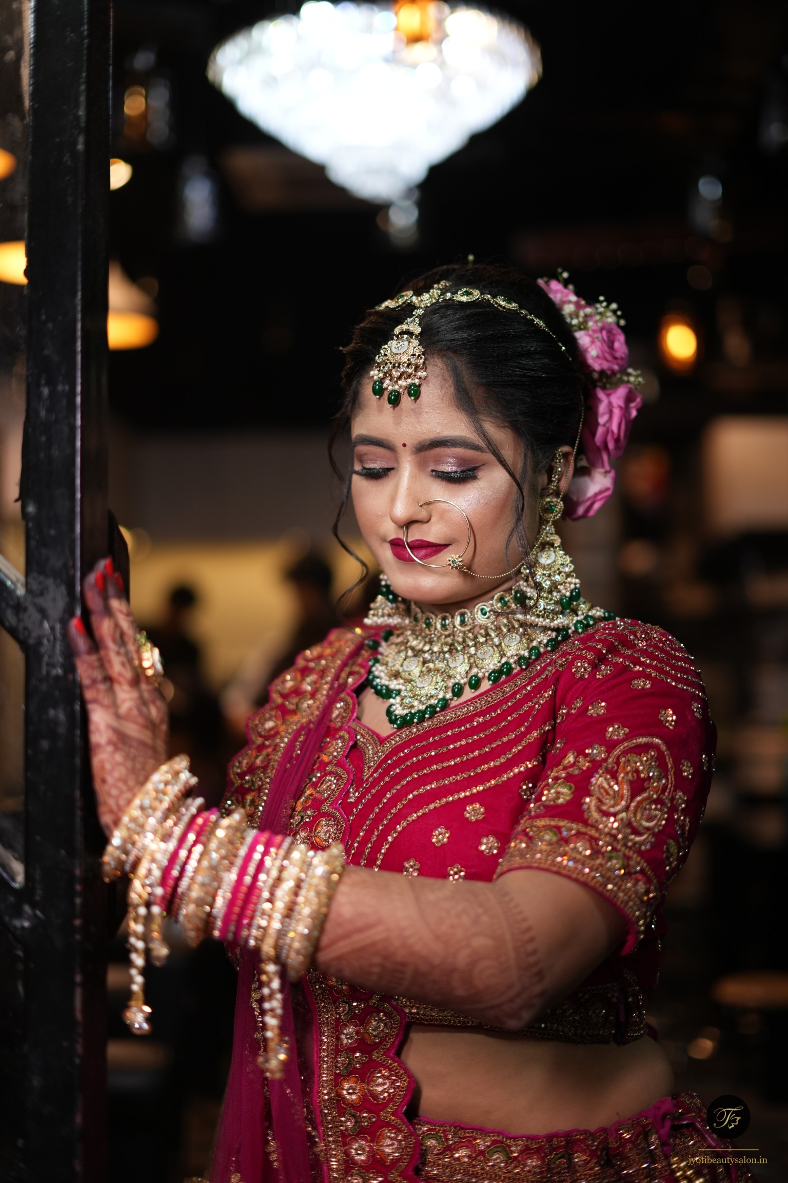 Bride in magenta lehenga and green kundan jewelry by Jyoti Beauty Salon in Chapra Bihar