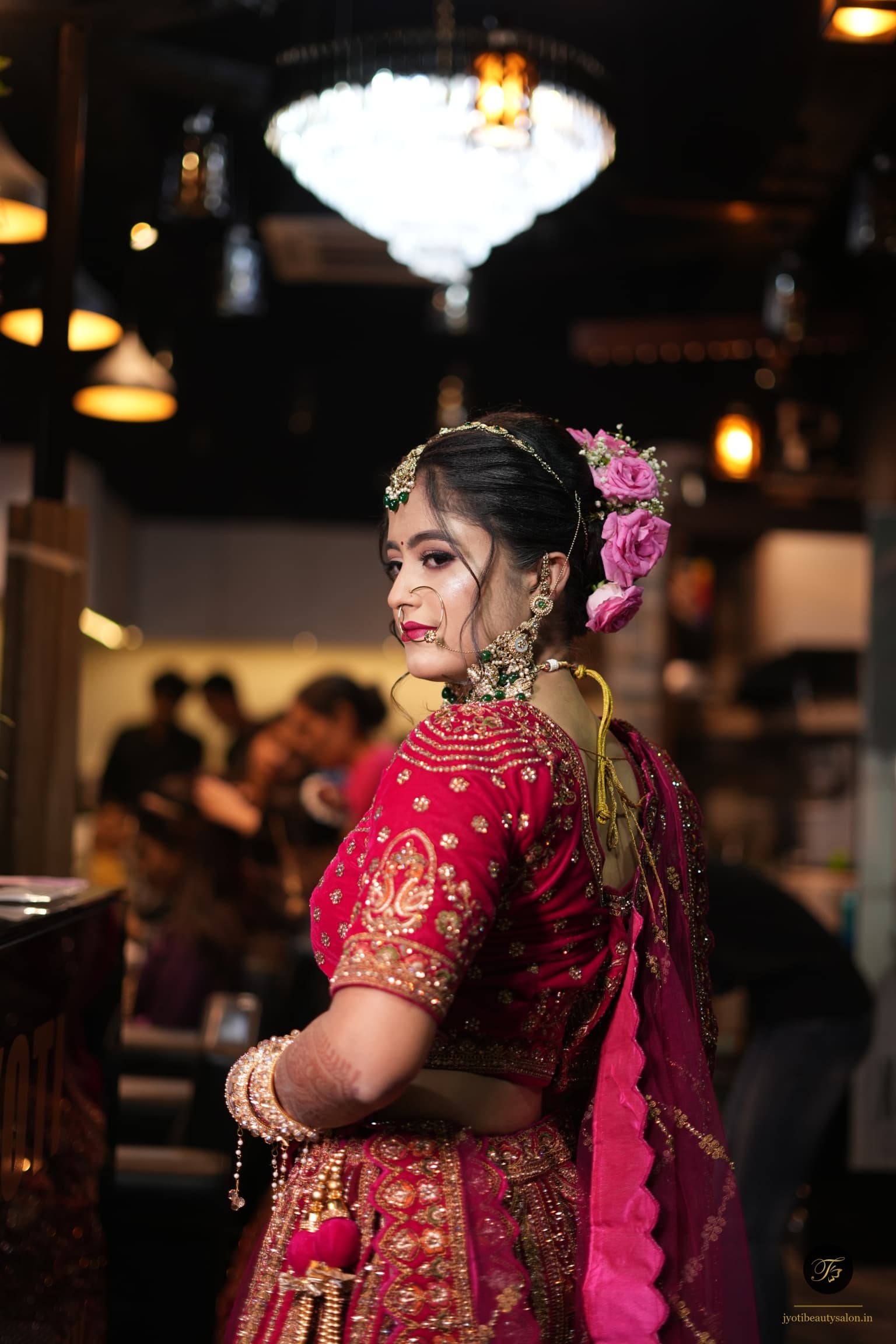 Bridal magenta pink lehenga makeup with fresh rose hair accessories by Jyoti Beauty Salon in Chapra Bihar
