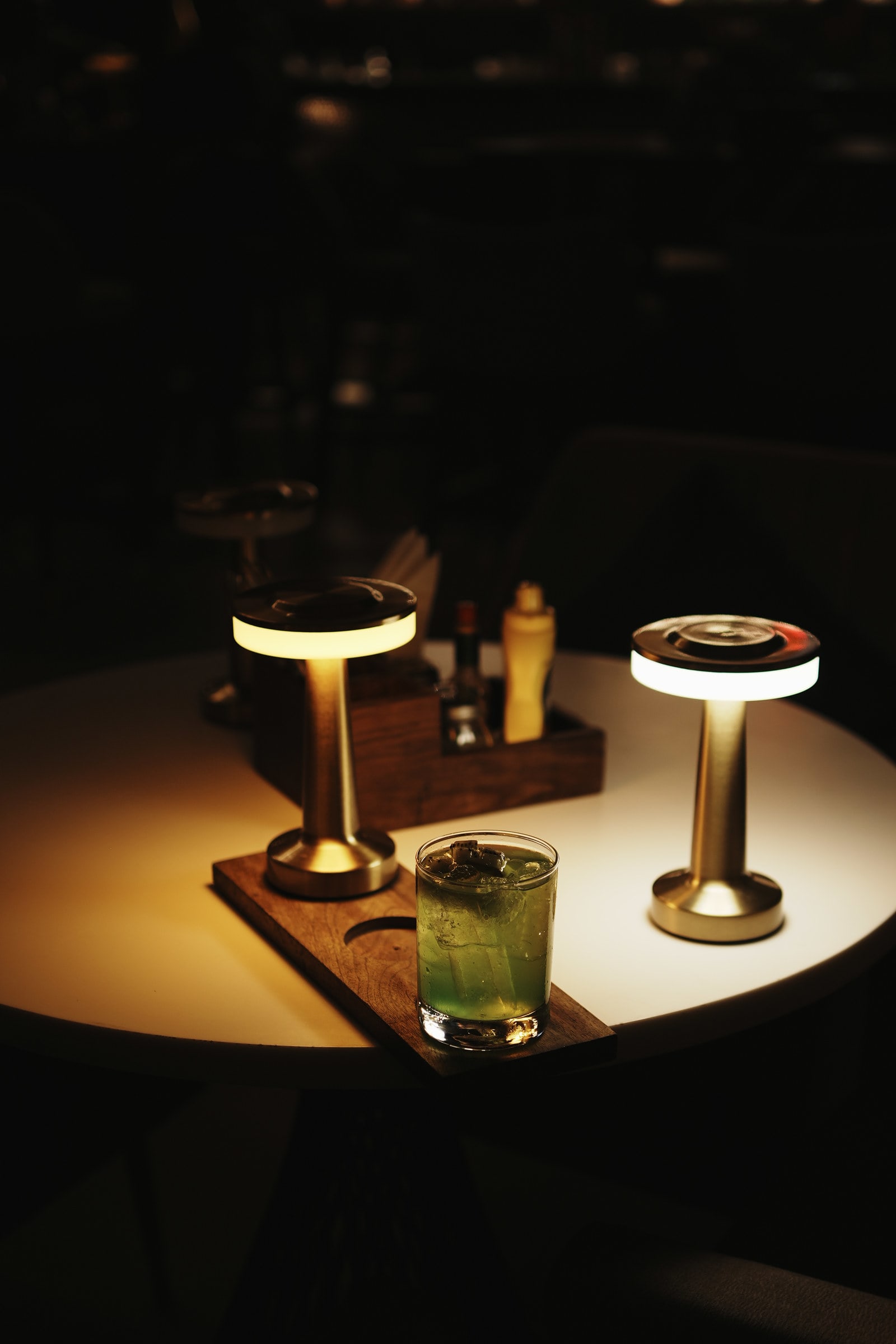 Glowing table lamps on a dark bar table