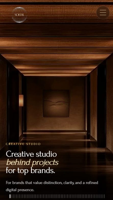 Mobile website design for a creative studio, with a warm lit corridor hero