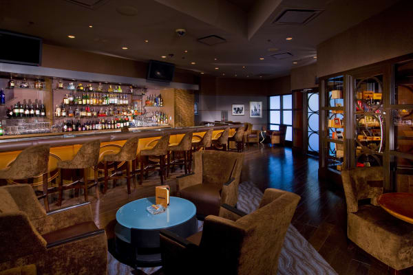 Legends of Fire cigar bar, filled with luxurious leather chairs and dark wood furniture.