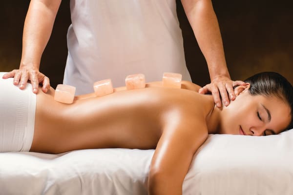 A woman getting a salt stone massage