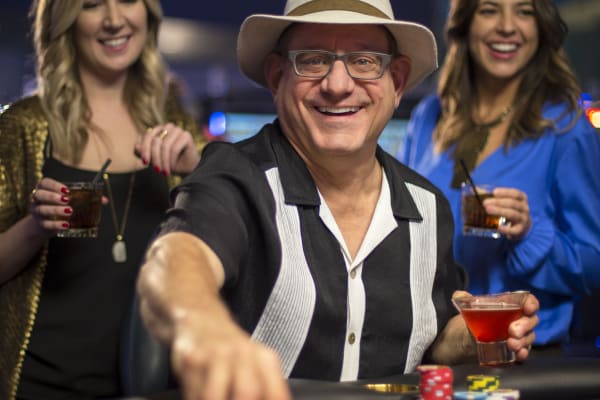 People having a good time at a gaming table.