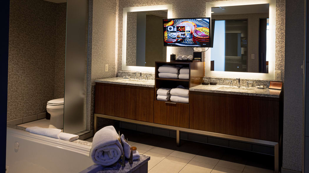 two lighted vanities and sinks in the bathroom