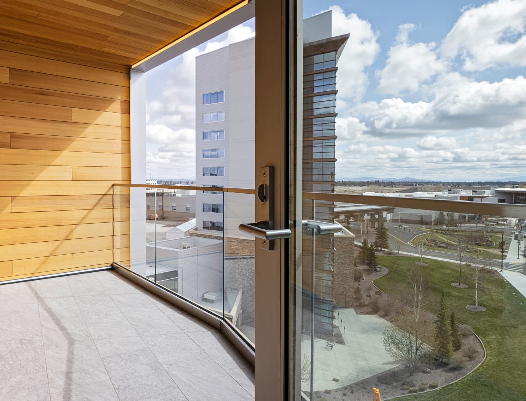 a photo of the balcony area of the Luxe King Suite, showing large windows and a view.